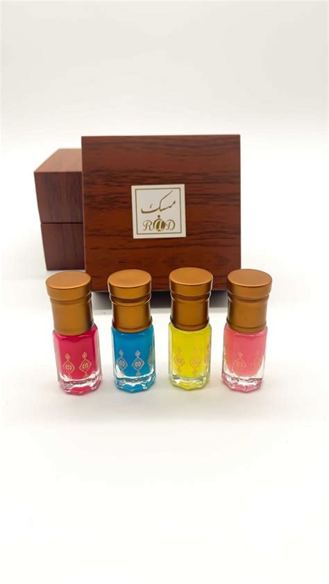 Four Small Glass Jars With Wooden Lids In Front Of A Box On A White