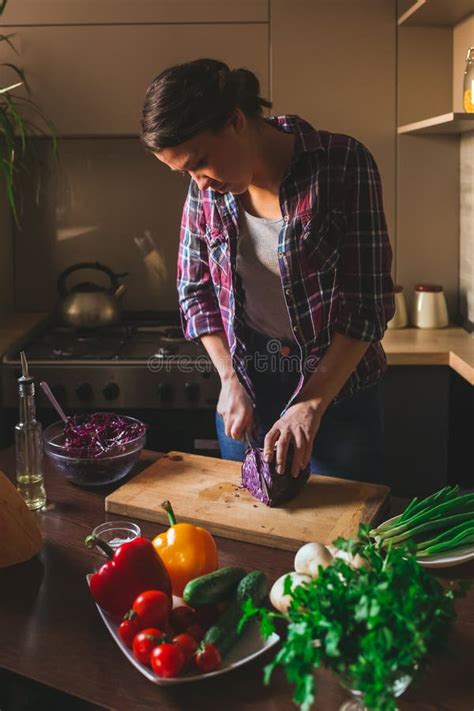 Beautiful Brunette Working In The Kitchen Woman Cuts Vegetables Stock Photo Image Of Fresh