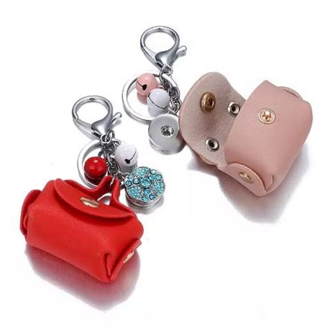 Two Purse Shaped Keychains Sitting Next To Each Other