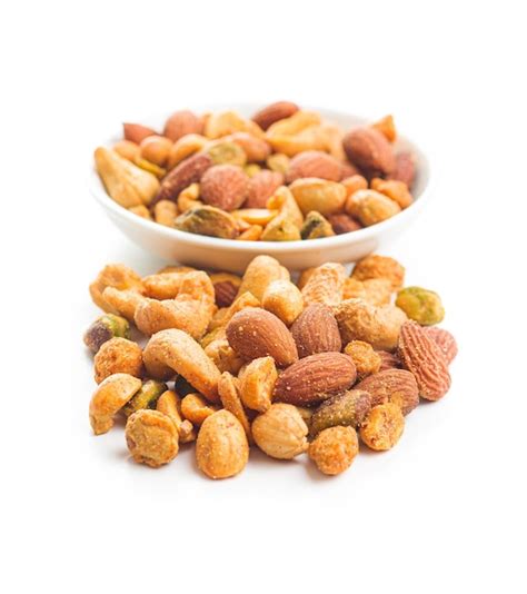 Premium Photo Spicy Flavoured Nuts Mix Of Nuts Isolated On White