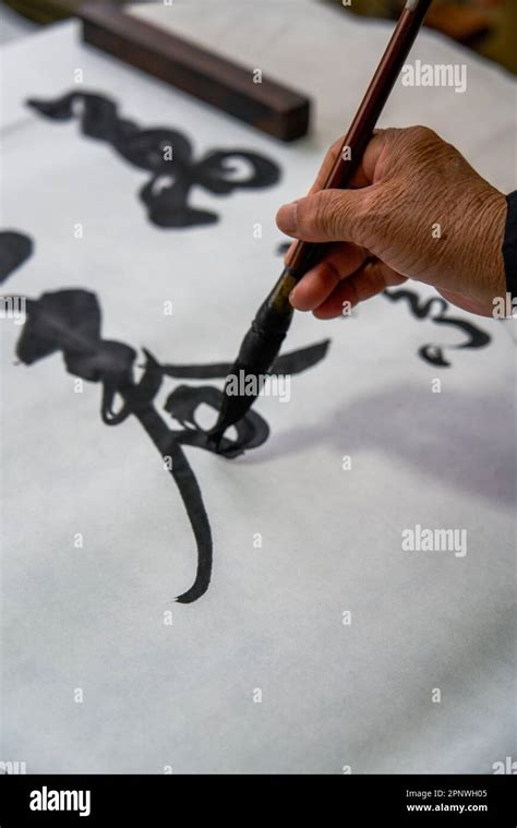 An Old Chinese Calligrapher Is Writing Brush Characters Creating