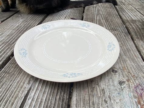 Cream Colored Colored Corelle With White And Blue Floral Pattern