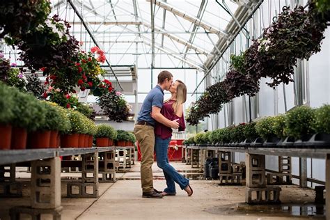 Engaged Couple Kissing In A Greenhouse Couple Photography