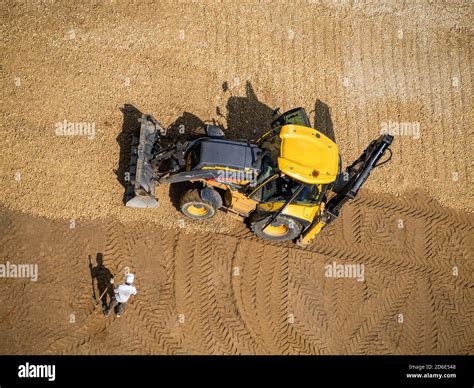 Wheeled loader in action at a road construction site Stock Photo - Alamy