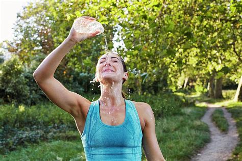 Young Woman Pouring Water Over Face Photograph By Science Photo Library