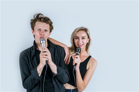 Premium Photo Happy Portrait Of Couple Holding Microphone And Sing A Song