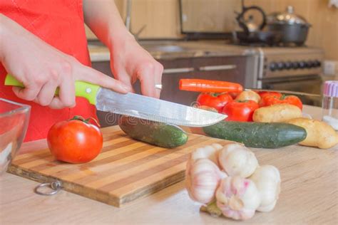 Young Woman Cooking in the Kitchen. Cropped Image of Young Girl Cutting ...