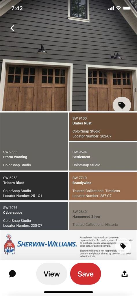 The Color Scheme For This House Is Gray And Brown With Two Garage