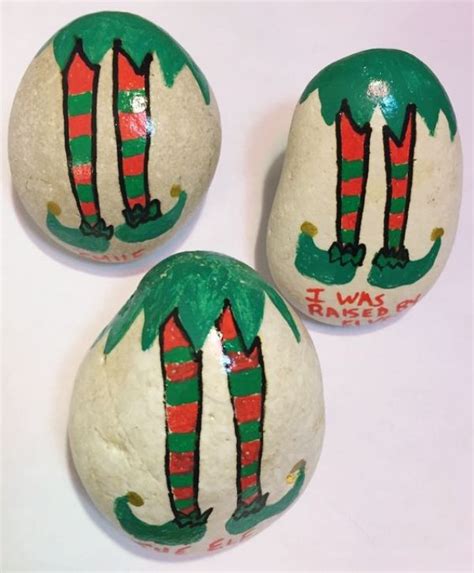 Three Painted Rocks With Christmas Stockings On Them