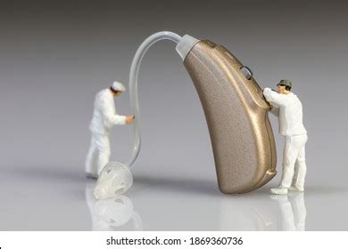 Audiologists Doing Hearing Aid Maintenance Stock Photo 1869360736