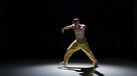 Breakdance Dancer In Yellow Suit With Naked Torso Dance On Black