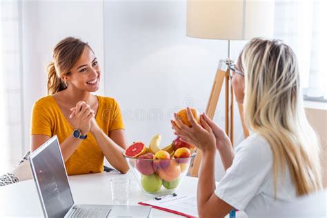 Female Nutritionist Giving Consultation To Patient Making Diet Plan