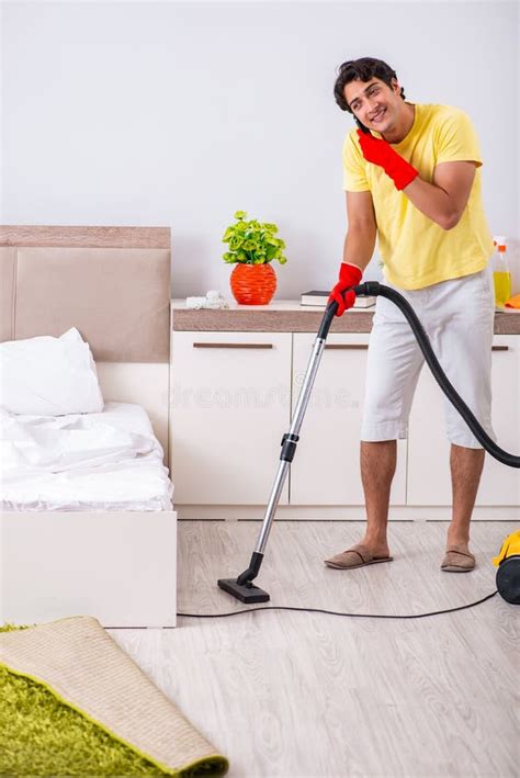 The Young Handsome Man Cleaning In The Bedroom Stock Photo Image Of