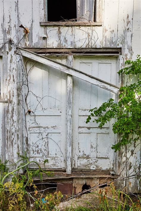 Double Doors On Front Of Abandoned Country House With White Chipped