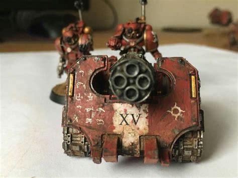 Some Red And Black Warhammers Are Sitting On A White Tablecloth With