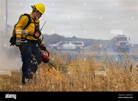 A Firefighter With The Camp Pendleton Fire Department Ignites Brush