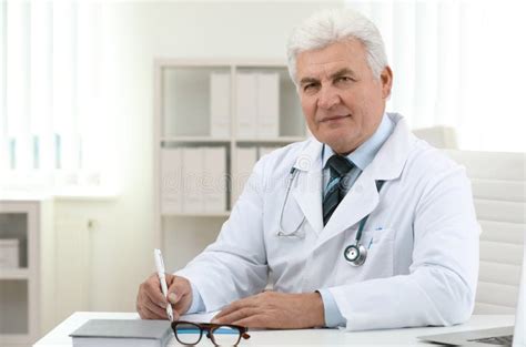 Portrait Of Senior Doctor In Coat At Workplace Stock Image Image Of