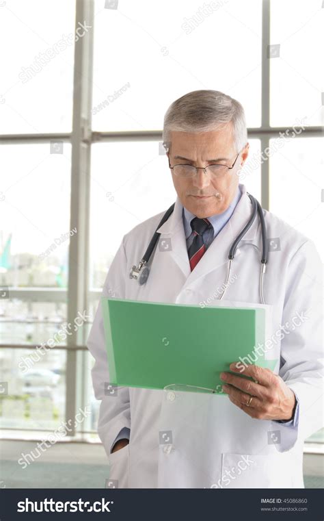 Middle Aged Doctor Reading Chart Front Stock Photo 45086860 Shutterstock