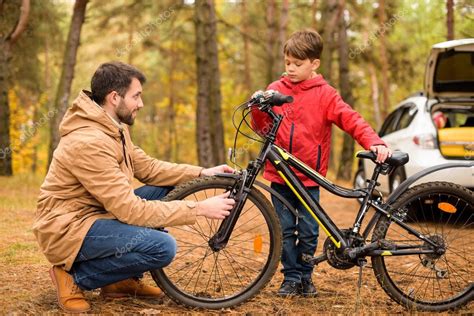 Father Teaching Son To Ride Bicycle Stock Photo Arturverkhovetskiy