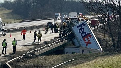 FedEx Tractor Trailer Hangs Off New York Overpass Following Crash