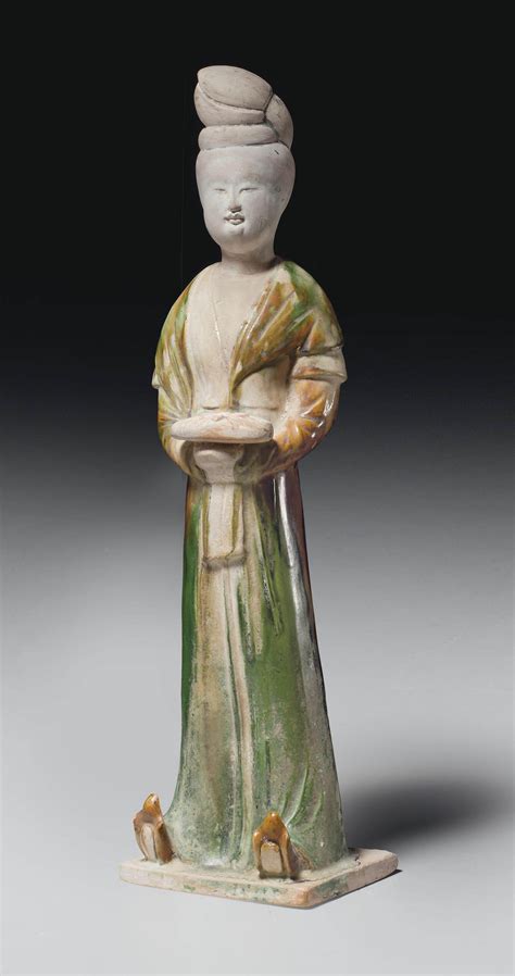 A SANCAI GLAZED POTTERY FIGURE OF A STANDING LADY TANG DYNASTY 618