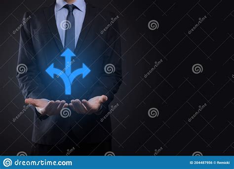 Businessman In A Suit Holds A Sign Showing Three Directions In Doubt