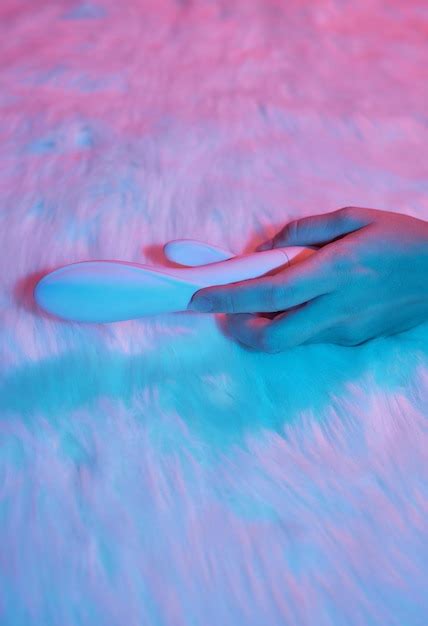 Premium Photo Desire Concept Woman Lying In Bed Holding A Dildo Vibrator In Her Hand To Help