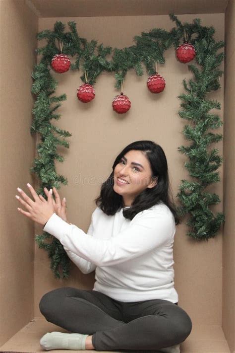 25 Year Old Latina Woman Inside A Cardboard Box Decorated As A Gift To Celebrate Christmas And