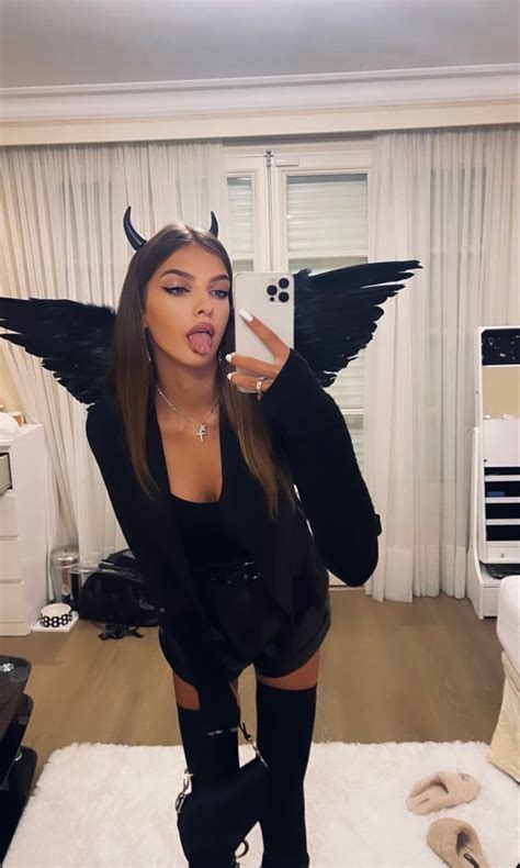 A Woman With Wings On Her Body Taking A Selfie