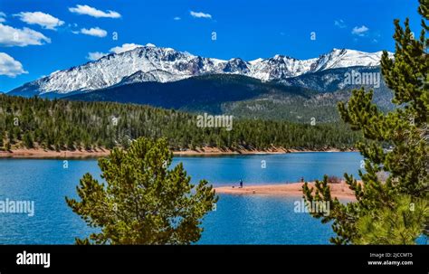 Pikes Peak Panorama Snow Capped And Forested Mountains Near A Mountain