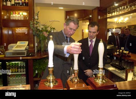 Prince Charles pulls a pint at the Poet Laureate Pub in Poundbury Stock ...