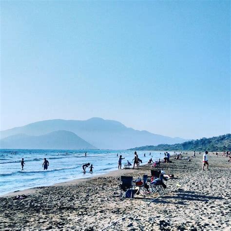 Premium Photo People At Beach Against Clear Blue Sky