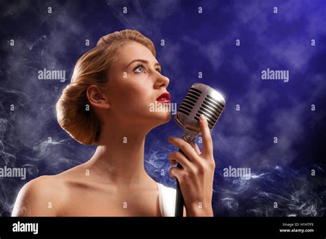 Beautiful Blonde Woman Singer With A Microphone Stock Photo Alamy