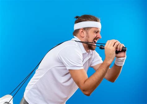 Free Photo Unpleased Young Handsome Sporty Man Wearing Headband And