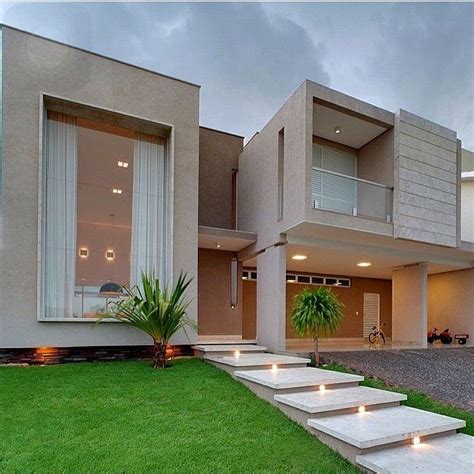 A Modern House With Steps Leading To The Front Door