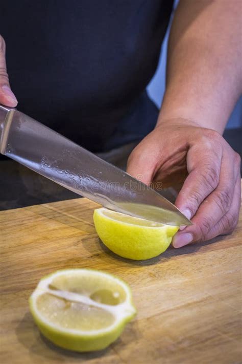 Human Slicing Yellow Lemon Picture Image