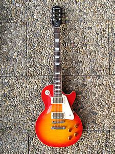 Royalty-Free photo: Orange and white electric guitar | PickPik