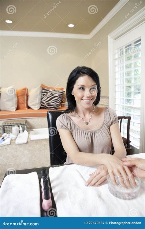 Happy Woman Getting Herself Pampered In Beauty Salon Stock Image