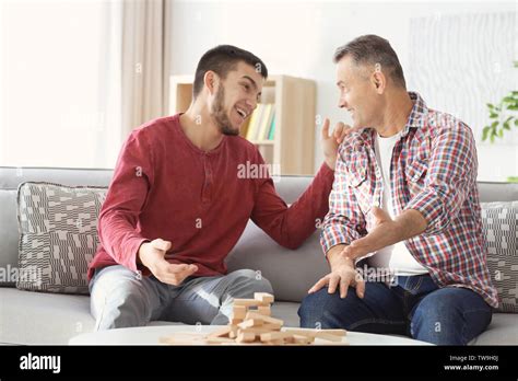 Mature Man Playing Board Game With His Son At Home Stock Photo Alamy