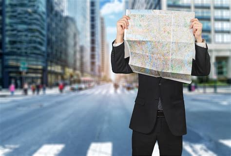 Premium Photo Businessman Lost In Field Using Map