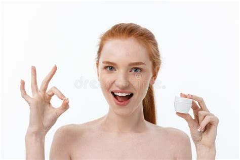 Portrait Of Beautiful Woman Smiling While Taking Some Facial Cream