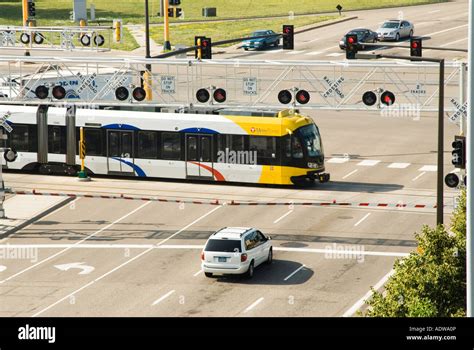 A Light Rail Mass Transit Train Crossing An Intersection In Stock Photo