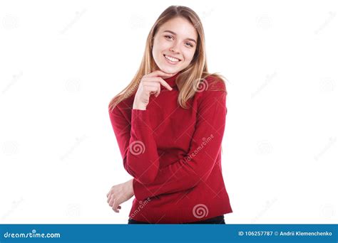 Young Girl Stands With Her Hand On Her Chin And Smiles Cutely