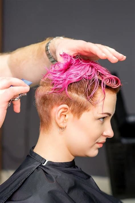 Haircut Of Dyed Short Pink Wet Hair Of Young Caucasian Woman By A Male
