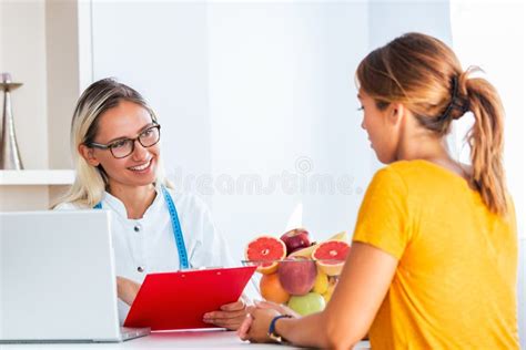 Doctor Nutritionist Dietician And Female Patient On Consultation In