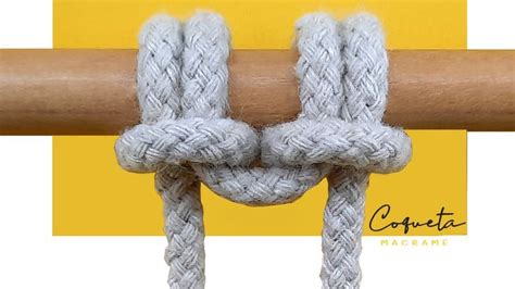 Two White Ropes Connected To Each Other On Top Of A Wooden Pole With