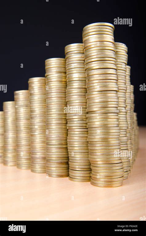 Golden coins in high stacks Stock Photo - Alamy