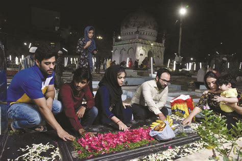 Devotees Offer Flowers And Prayers At The Grave Of Their Loved Ones On