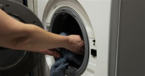 Premium Photo Woman Hands Putting Dirty Clothes Into Washing Machine