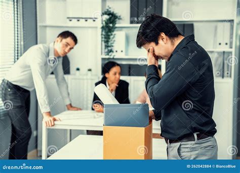 Sad Employee Packing His Belongings After Being Fired For Not Being